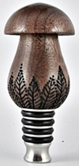 black walnut mushroom with woodburning leaves on a stainless steel cork stopper