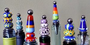 handmade beads on threaded rods on top of stainless steel bottle stoppers