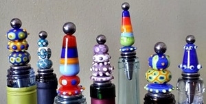 handmade beads on threaded rods on top of stainless steel bottle stoppers