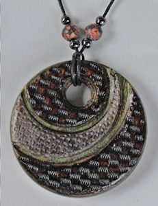 pendant with off-set cuts and branding