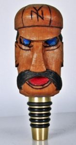 wood carving on brass whiskey stopper