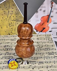 cello turned from wood on top of stainless bottle cap opener