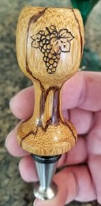 engraved bottle stopper on a stainless stopper base
