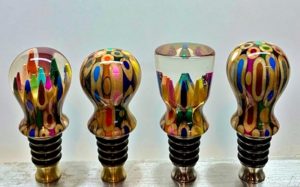colored pencils in resin on bottle stoppers